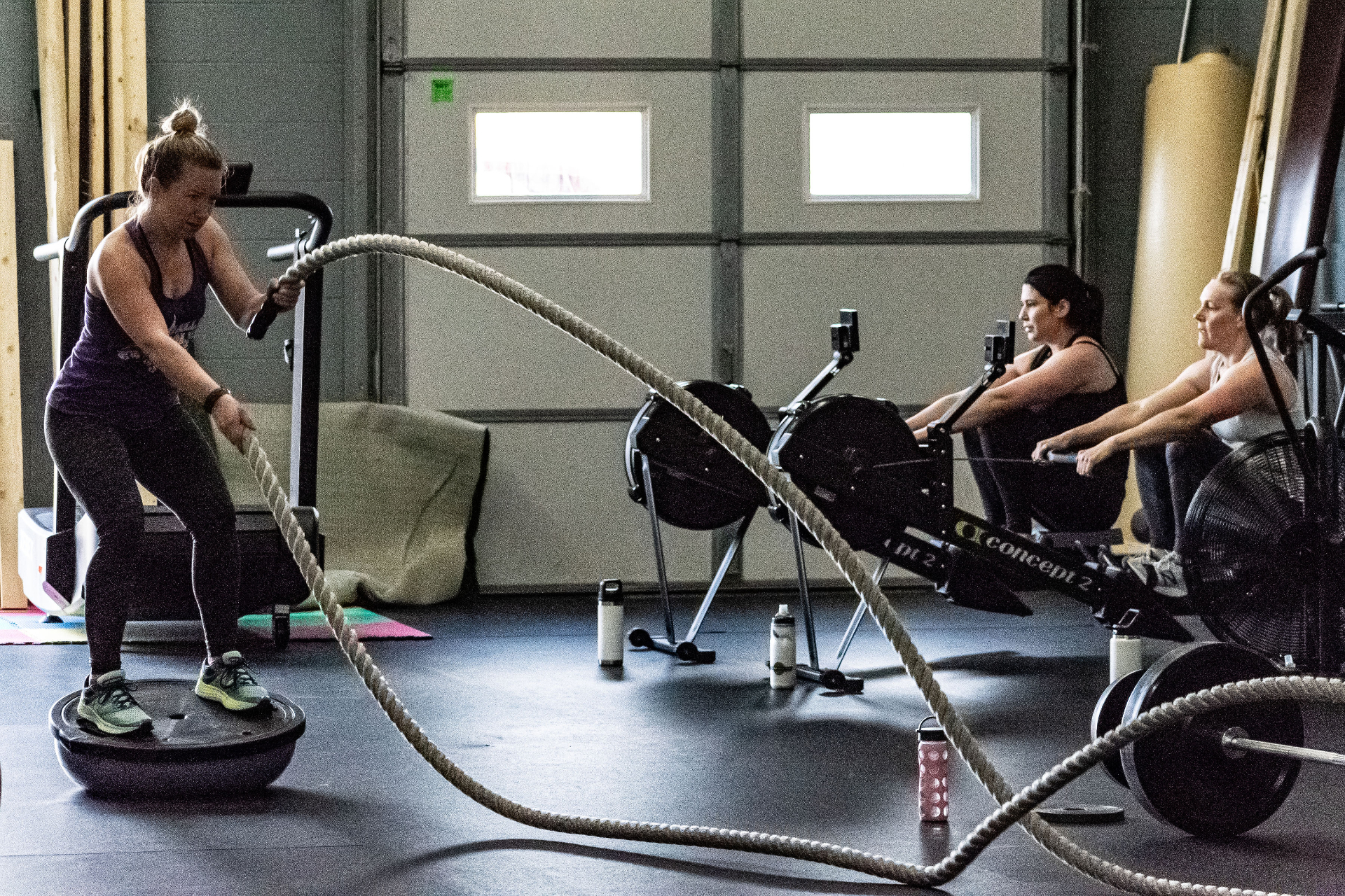 Members training with battle ropes and rowers at Envision Fitness in Hopkins, MN