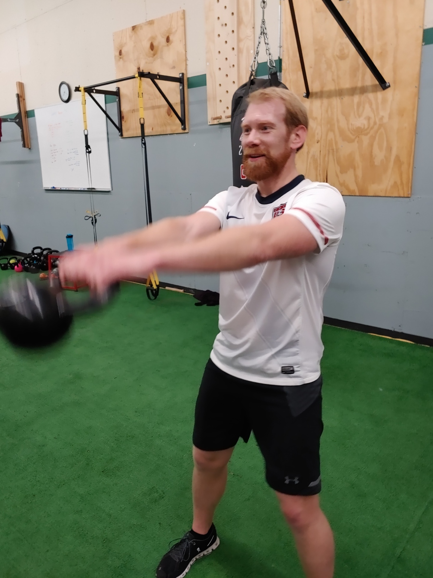 Eric performing a kettlebell swing during a training session at Envision Fitness